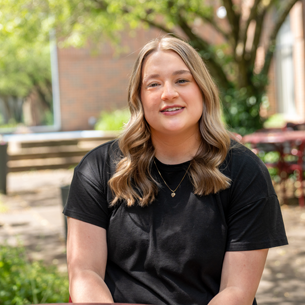 Photo of Jaylee sitting on bench