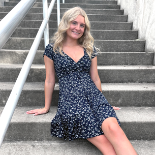photo of mikaila sitting on stairs in blue dress
