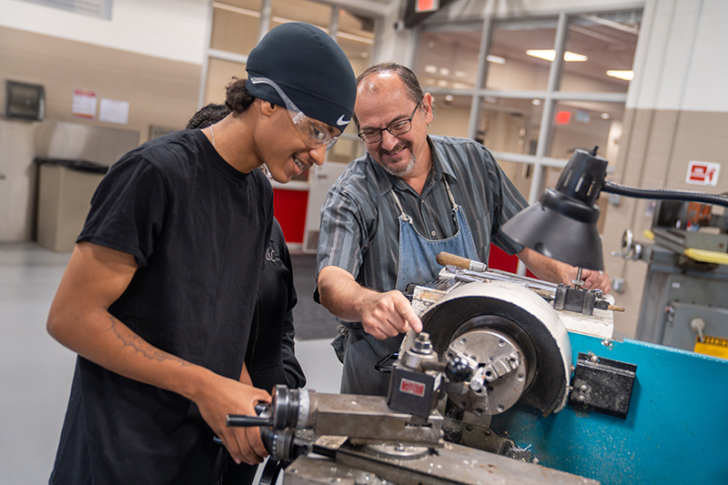 Owens instructor Kevin Walker works with a Harbor Pre-Apprenticeship student in the Haas Machining Lab.
