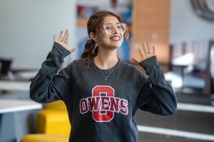 Owens student in Owens-branded shirt