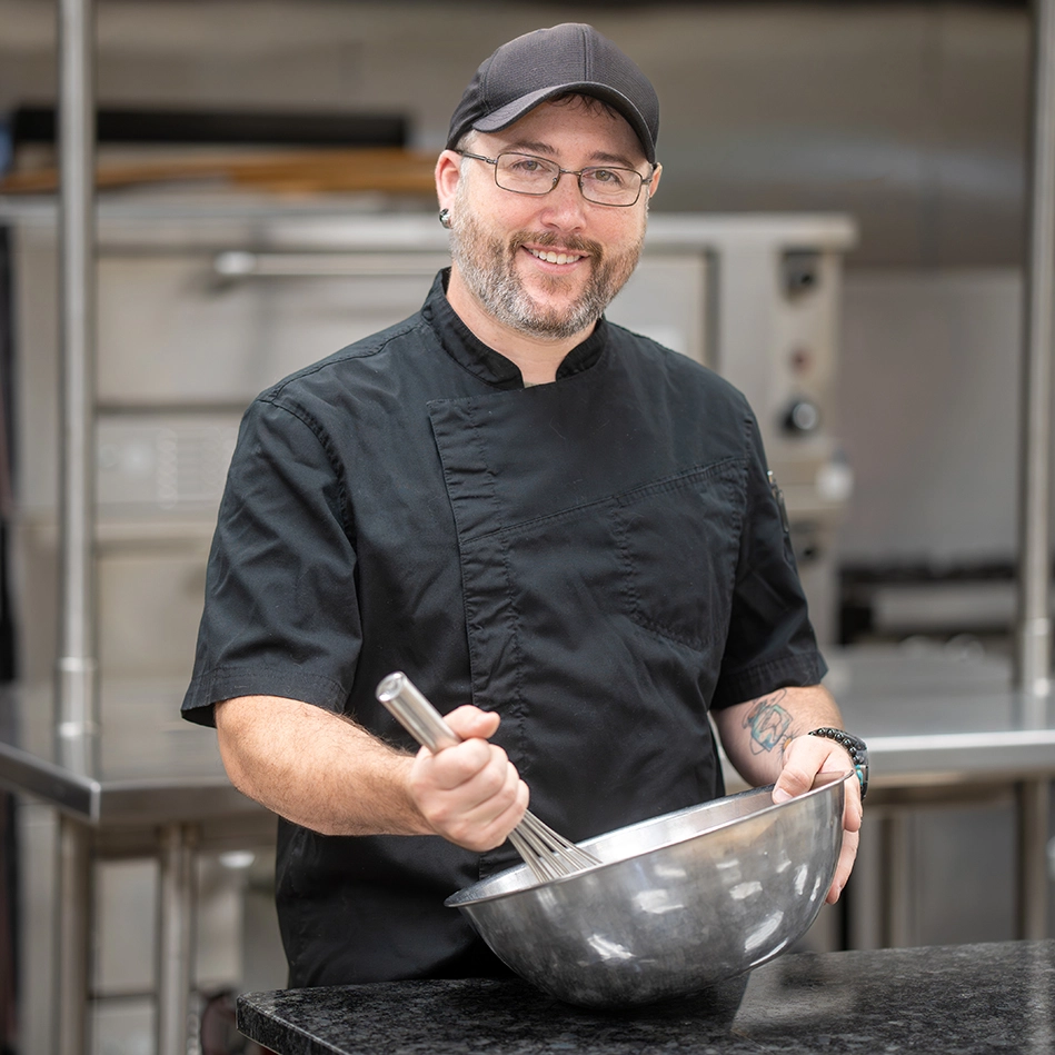 http://Owens%20culinary%20student%20mixing%20food%20in%20bowl