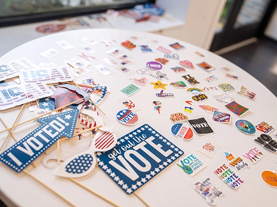 table with an array of vote stickers for students