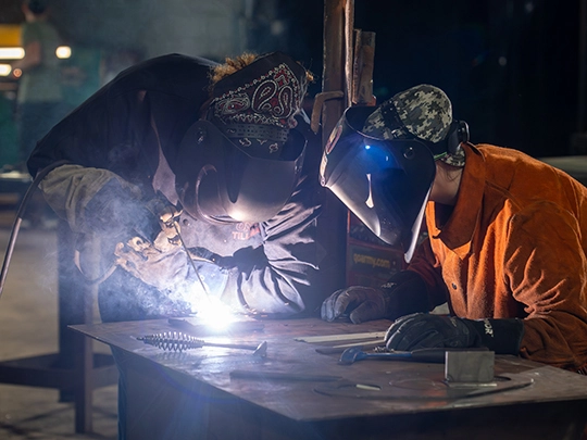two people welding