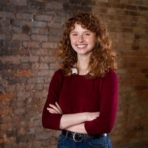 portrait of grace crossing arms wearing red sweater