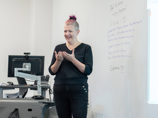 Instructor teaching sign language in a classroom