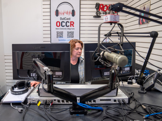 Woman sitting at a desk working on a radio show