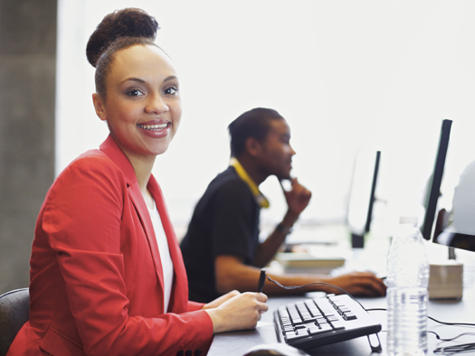 Woman sitting at a desk working on a computer