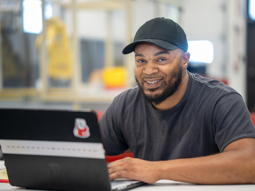 student sitting at computer in mechatronics lab