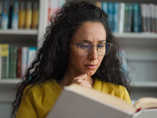 student attentively reading a book