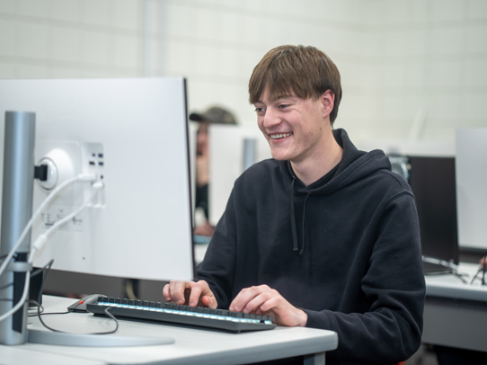 Man sitting at a desk working on a computer