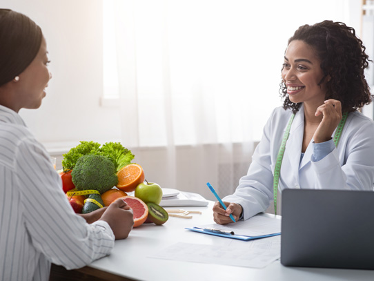 Woman speaking to another woman while writing stuff down