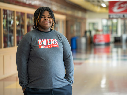 Man standing in the hallway of Owen's Community College