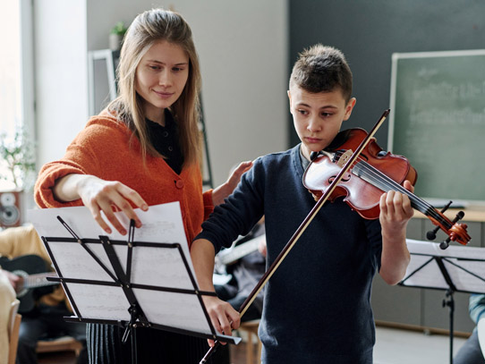 instructor with student playing violin