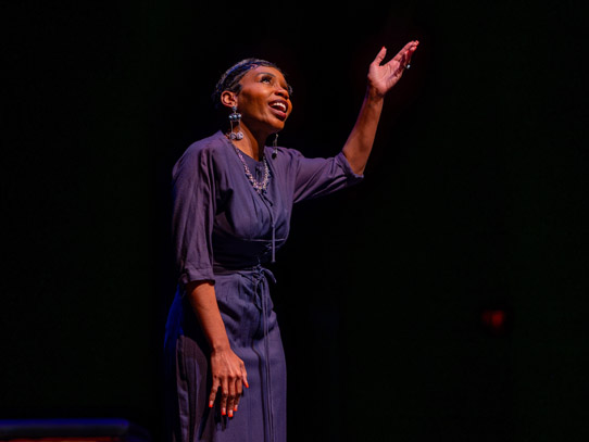 Woman performing on stage, singing